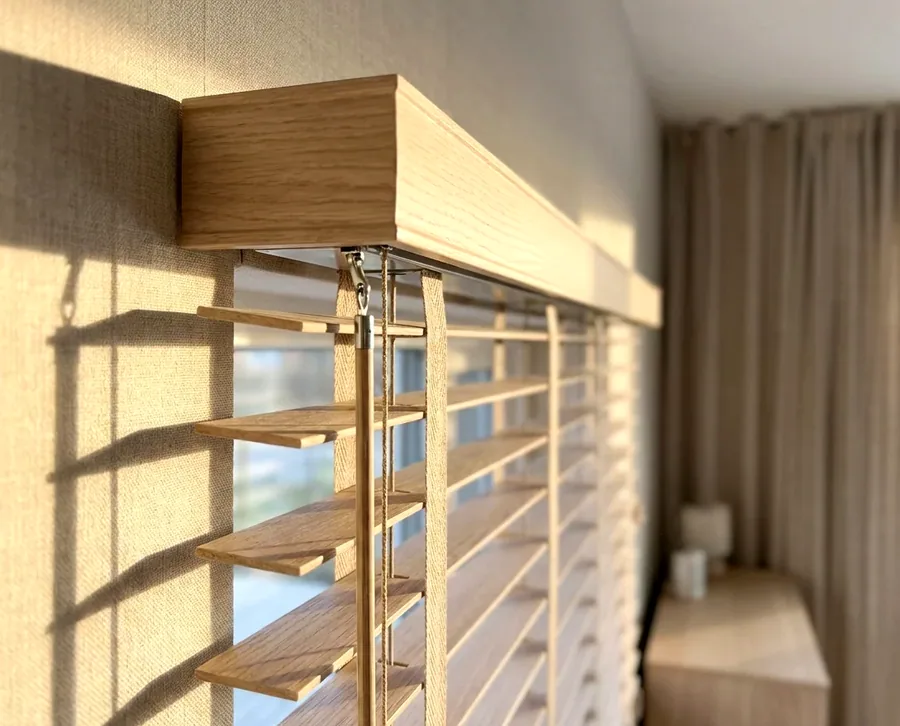 Close-up of a timber venetian headrail and tilt mechanism, the hardware a blind repair usually turns on